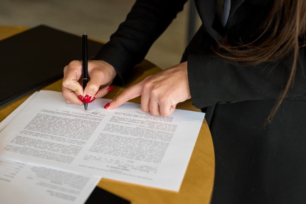 brunette-businesswoman-writing-document.jpg
